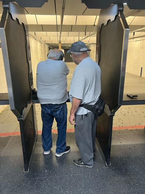 My dad is teaching his older brother how to shoot properly